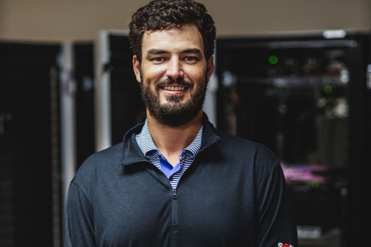 Sonitrol Employee in front of servers