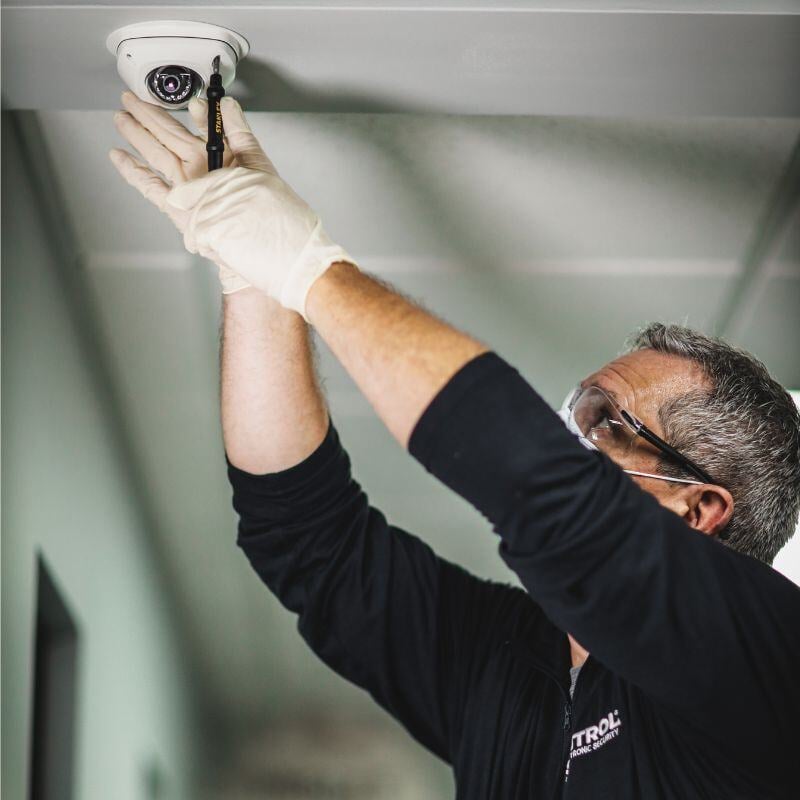 Technician installing Sonitrol camera