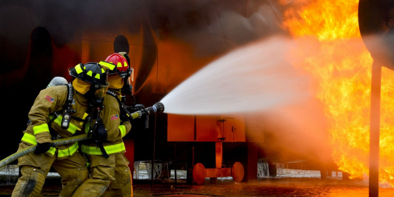 Firefighters battling a flame