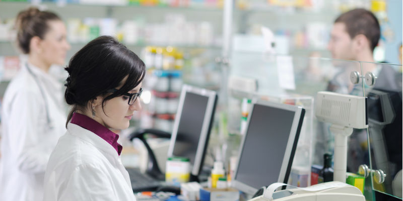 pharmacists working behind counter 