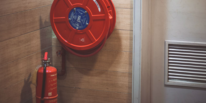 Fire extinguisher and hose in business building