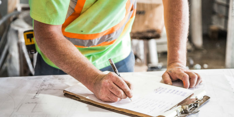 Construction site worker taking notes