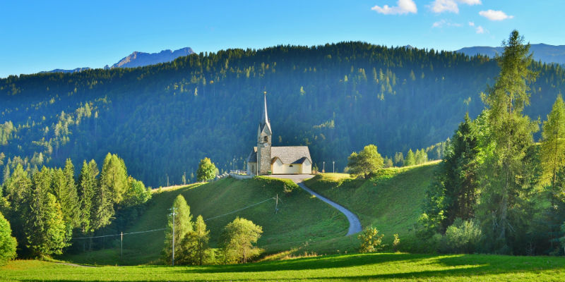A church surrounded by mountains
