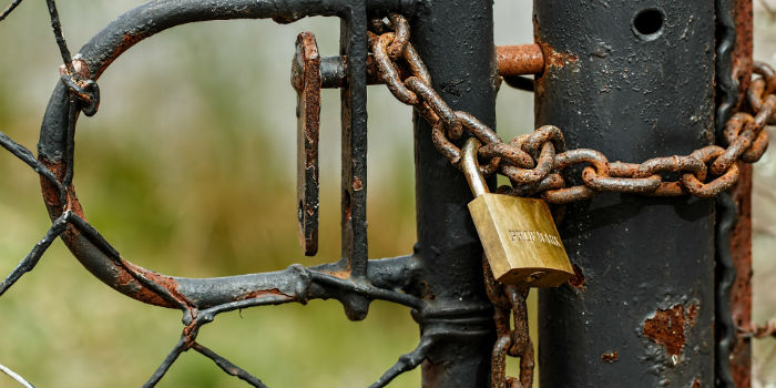 Rusty business gate padlocked together