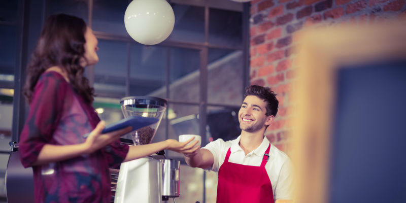 Retail worker serving a customer